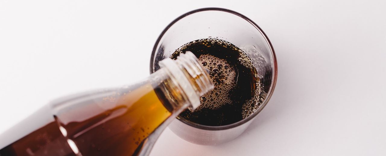 pouring soft drink in a glass